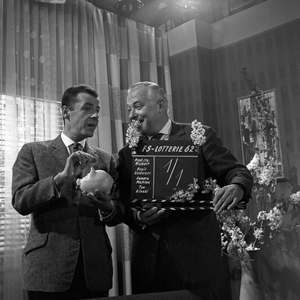 TV presenter Chris Howland and production manager Richert promoting Germany TV lottery 1962 at Hamburg, Germany 1960s