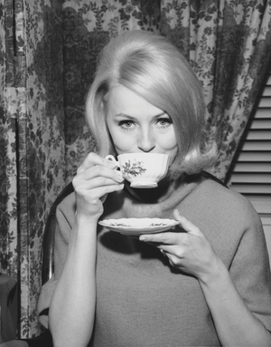 Portrait of a young woman drinking from a tea cup