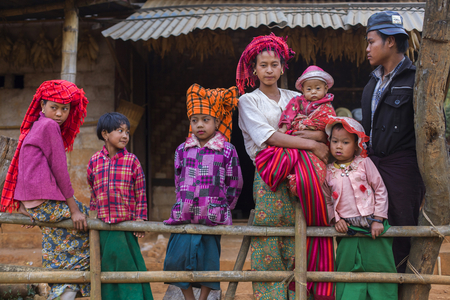 A Pa-O family on the doorstep. Small village in Shan State, Myanmar (photo)