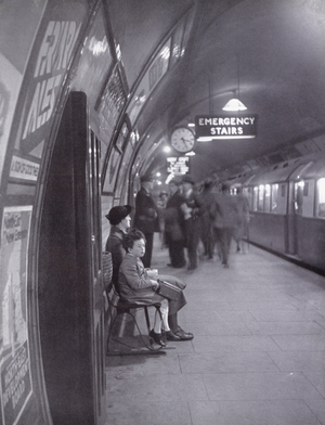 Waiting for a train on the London Underground (b/w photo)