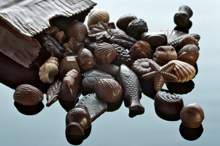 Designer pieces of chocolate spills out on a chocolate bag, 2022 (photo)