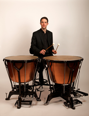 Timpanist playing two calf-headed Ringer style timpani.