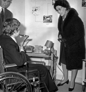 Secretary of State for Social Action and Readaptation Marie-Madeleine Dienesch at the Inauguration of the Documentation and Research Information Centre on the premises of the French National Liaison Committee for the Readaptation of Handicaps Bd Raspail Here In The Company Of A Handicap Who Arrives To Speak By Telephone Using A System Allowing Him Blowing In The Pipe December 1, 1969 (b/w photo)