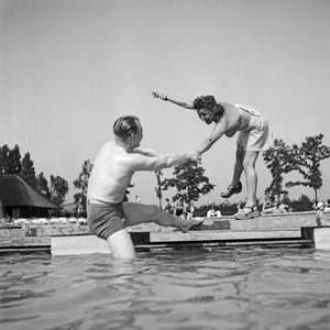 A woman and a man cooling themselves in a public pool at Bad Rippoldsau Schapbach in Black Forest, Germany 1930s (b/w photo)