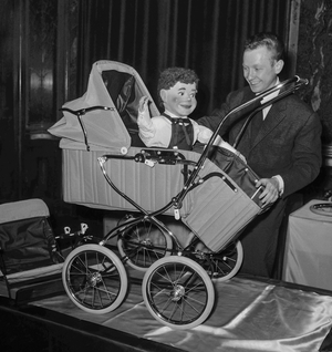 Omer, young ventriloquist, in a newtype of baby carriage, Paris, March 16, 1959 (b/w photo)