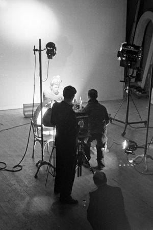 Arranging and illuminating a woman in a still life at a photo studio, Germany 1930s (b/w photo)