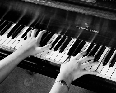 Close-up of a person's hands playing the piano