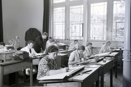 Trainees of a textile factory in Krefeld are designing new patterns for the tixtile production during drawing classes, Germany 1930s (b/w photo)
