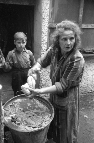 Refugee family in their home near Muenster, 1960 (b/w photo)