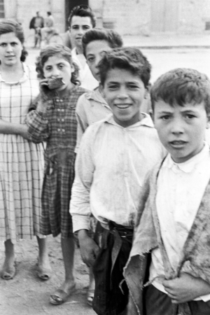 Children awaiting to be employed as nuts picker in Qualiano, Naples, Campania, Italy, 1954 (b/w photo)