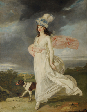 A Windswept Girl in a Turban walking with a Dog