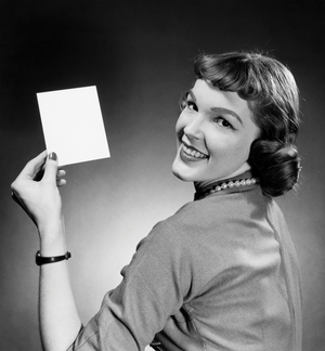 Portrait of a young woman holding a blank flash card