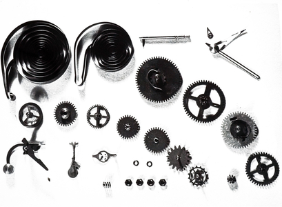 A photograph of moveable parts of a modern alarm clock, 20th century