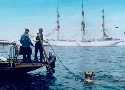 Diver diving in the ocean, 1920s