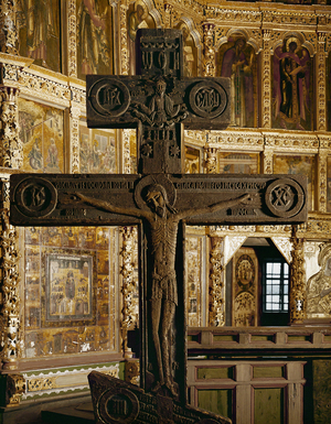 A wooden cross with an ematiated Christ under the figure of God the Father (photo)