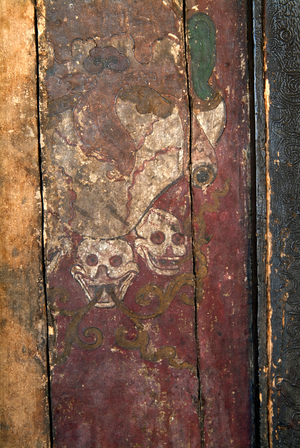 Tibetan Buddhism (Tantric Buddhism, Vajrayana): Two skulls (symbolizing 'impermanence') drawn on entrance door to Gonkhang ("Protectors of the Dharma") temple Thiksey (aka. Tikse) Gompa (monastery), Ladakh, Himalayas, Jammu and Kashmir, India (photo)