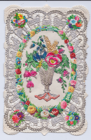 A Victorian silver embossed paper lace greeting card of a metallic vase with embossed flowers int it surrounded by a wreath of flowers, c.1880 (colour litho)