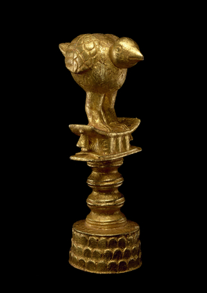 Umbrella finial of a bird on a stool, 20th century (wood and gold leaf)