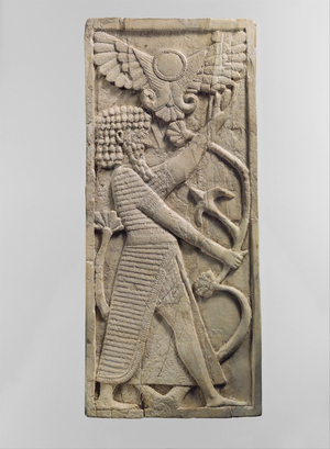 Furniture plaque carved in relief with a male figure grasping a tree, c.8th century B.C. (ivory)