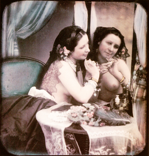 A semi-nude woman standing in front of a mirror with her breasts exposed wearing a pearl necklace, 1850 (hand-coloured stereoscopic daguerreotype)