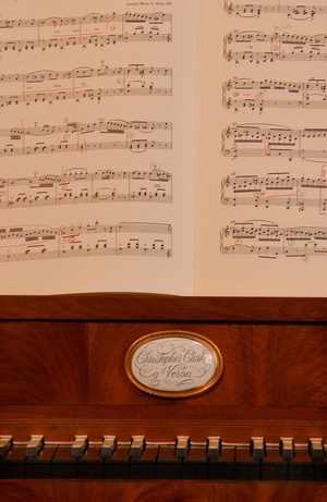 Piano keyboard and music, close-up.