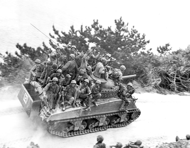Japan / USA: Tank-borne US infantry moving up to take the town of Ghuta. Battle of Okinawa, May 1945, photo by Robert L Keller (b/w photo)