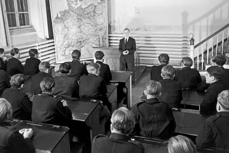 Original caption: Knowledgeable lectures unite the boys at the classroom in the evening and helps them to enrich their ken, Germany 1950