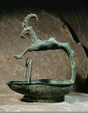 Bronze lamp with spout with jumping ibex …