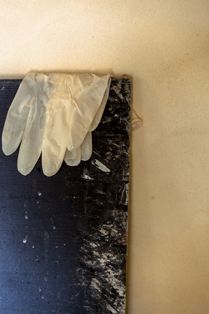 Plastic gloves on a wooden board, 2015 (photo)