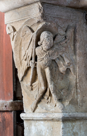 Angel fighting demons, 12th century (sculpture)