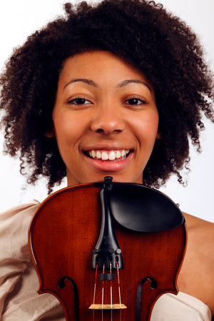 Violin player holding her instrument near her face