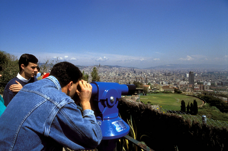 Tourists look at Barcelona in Spain through binoculars,..., 1991 (photo)