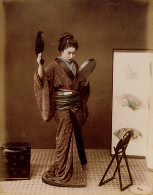 Woman in Photo Studio Holding Mirror, 1885-1900