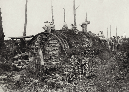 Burmese troops pulling down the old dug-outs for timber in Delville Wood, Summer 1917 (b/w photo)