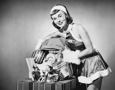 Portrait of a young woman holding a sack of Christmas presents
