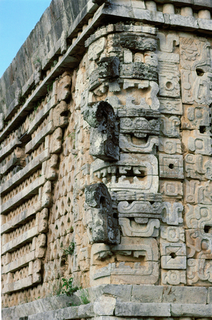 Masks of the rain-god Chac with his trunk-like nose, symbolising lightning, form the cornice of the east Building