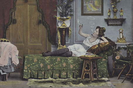 Woman smoking on a chaise longue (colour photo)
