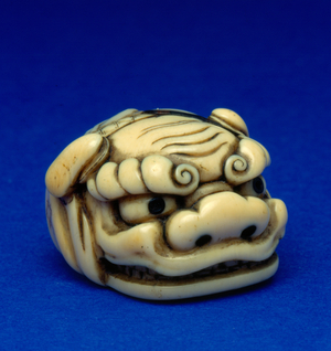 Japanese mask-style netsuke - Shishi (mythical lion) head, 1800-50 (ivory)