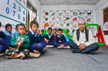 School children and teacher sitting on floor in classroom in rural Nepali school, 
Lwang Ghalel, Annapurna Conservation Area, Himalayas, Nepal (photo)