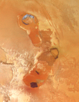 This photograph of Jupiter's satellite Io shows what appears to be a volcanic caldera that is venting gasses. Voyager.