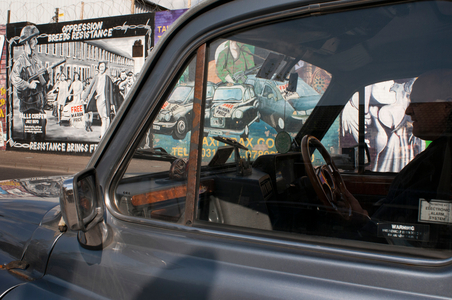 Belfast Black Taxi tours in front of one of the loyalist murals Falls road street, Belfast, Northern Ireland, UK (photo)