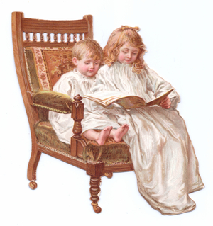A Victorian Die-cut shape card of two children sitting on an armchair looking at a book, c.1880 (colour litho)