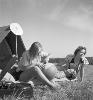 Young woman by their tent on summer vacation, Germany 1930s (b/w photo)