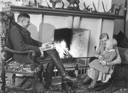 Family at the fireplace, 1936 (b/w photo)