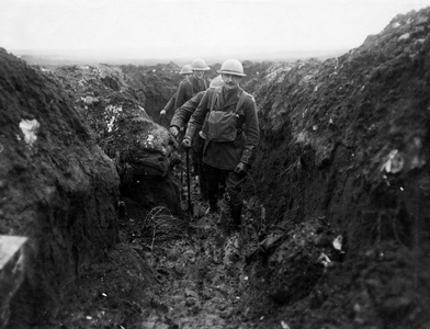 Official photograph taken on the British Western Front showing soldiers walking through trenches, 1917-1918 (photograph)