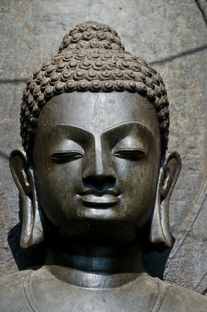 Head of black Shakyamuni Buddha statue, 7th century, said to be image of Siddharta Gautama, Swayambhu (aka. Monkey Temple), Kathmandu, Nepal (photo)