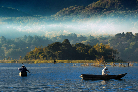 Men fishing in the traditional manner in Lake Atitlan, Guatemala, 2022 (photography)