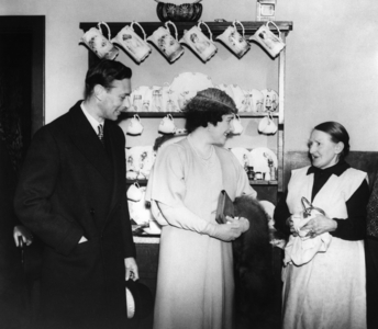 King George VI and Queen Elizabeth visiting Mrs Whitaker, 1938 (b/w photo)
