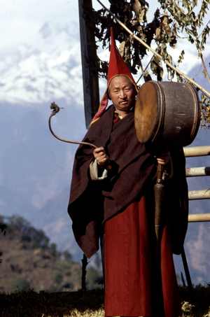 Shinglay Lama beating on large drum near Singhik, Sikkim 1969 January.