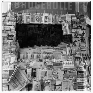 Image of a full display on a newspaper stall, Paris early early 1950's